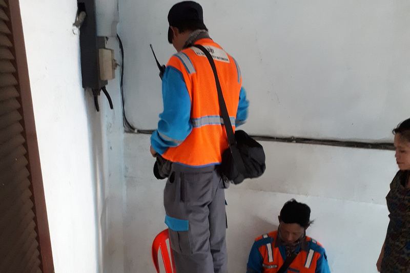 Electricians working on an electricity meter