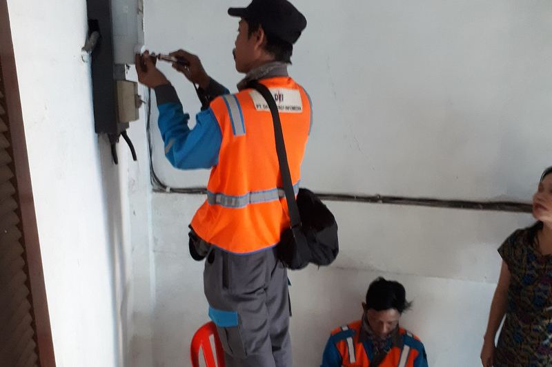 Close view of electricians servicing an electricity meter